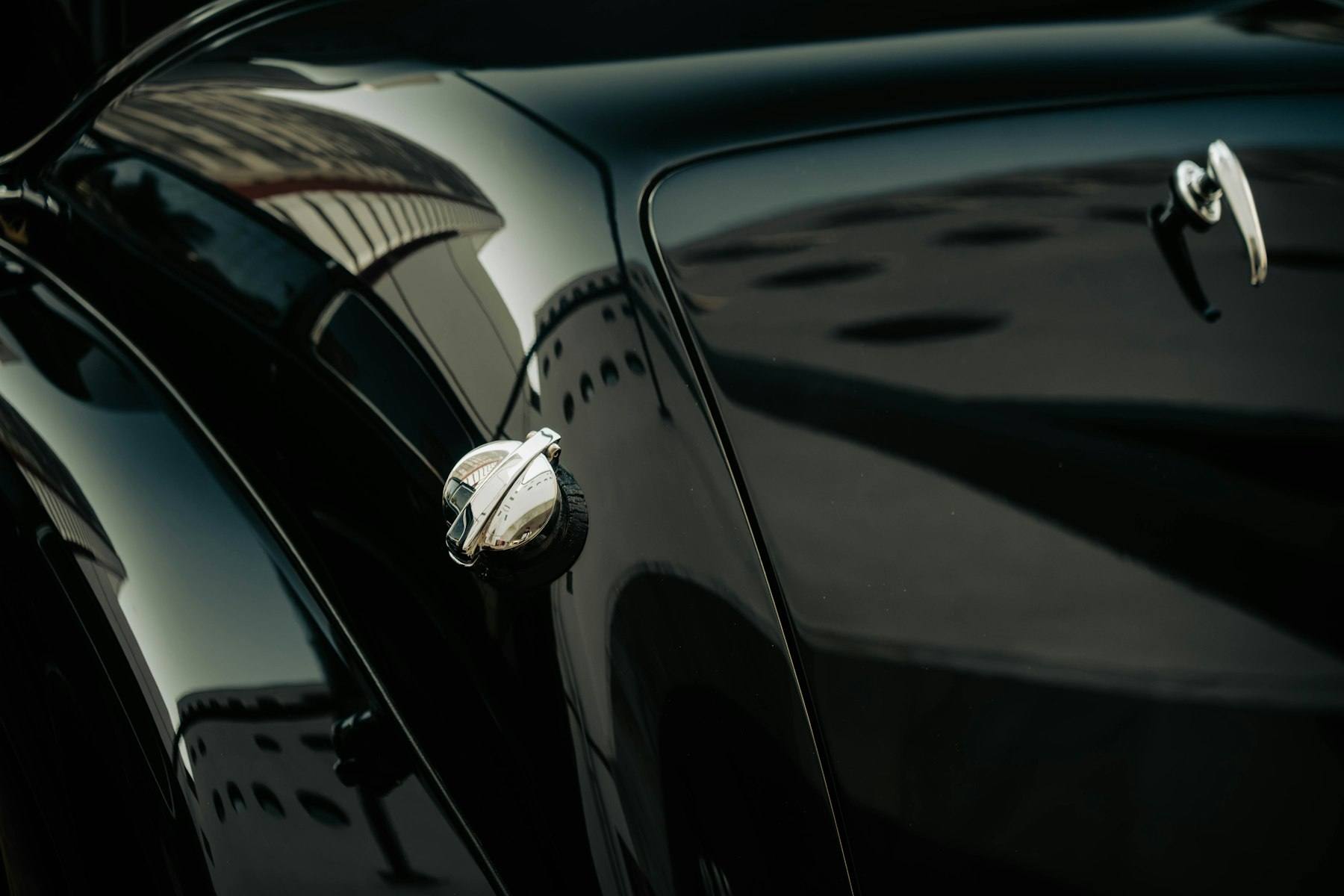 After correction: glossy black fender reflecting studio lights
